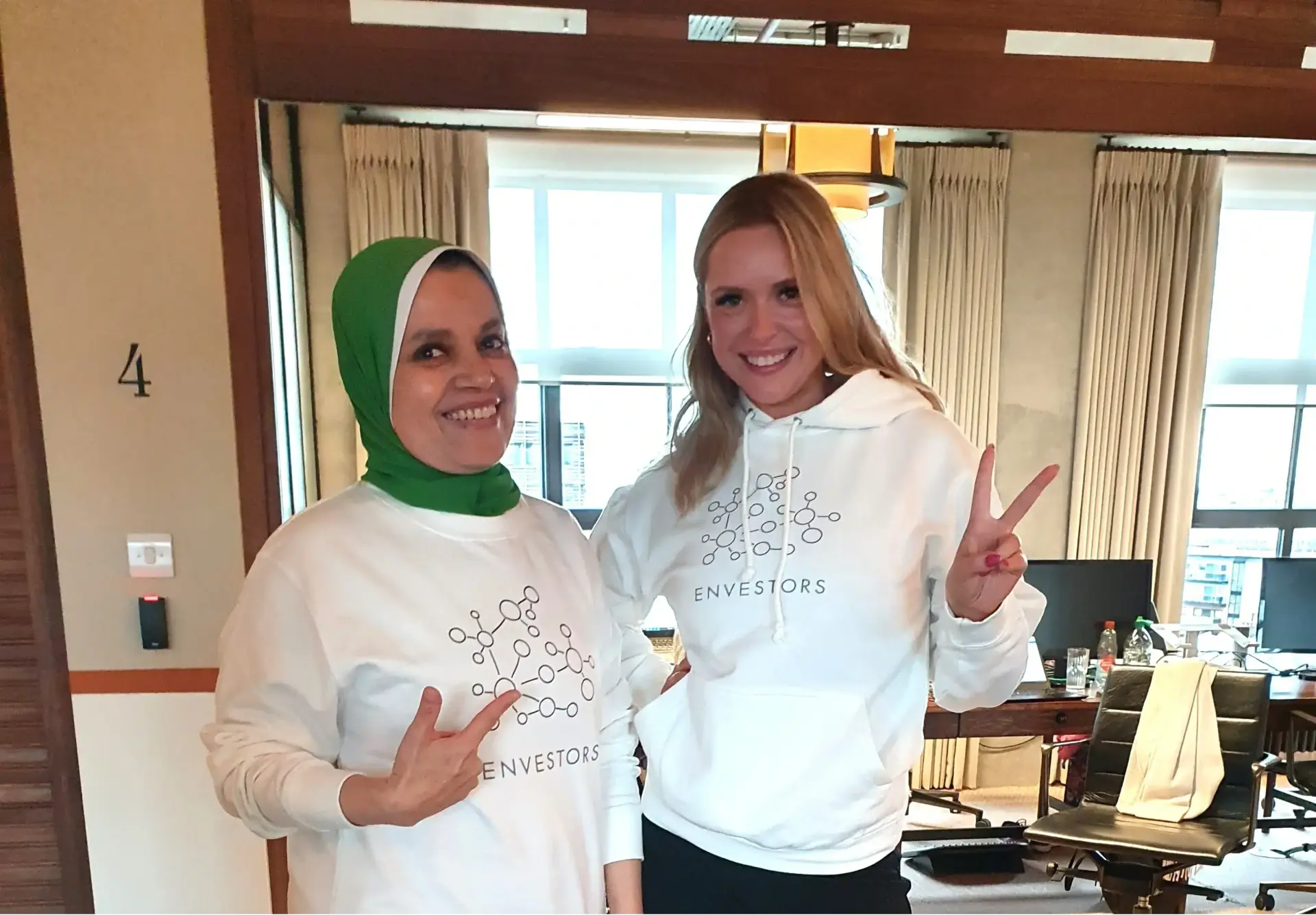 Two Envestors team members in Envestors sweatshirts